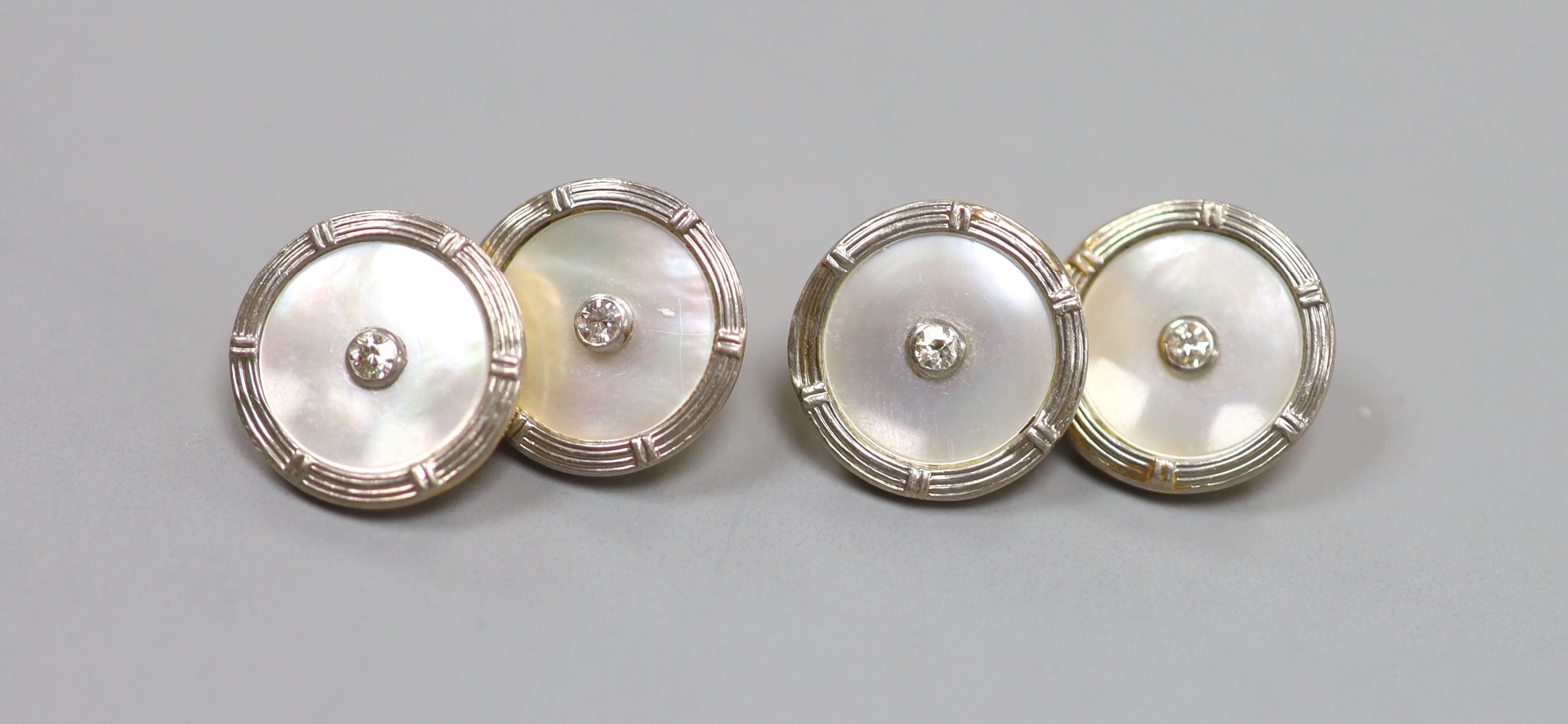 A pair of 18ct, mother of pearl and diamond set disc cufflinks